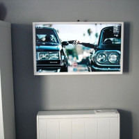 Small TV mounted on the wall West Sussex