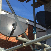 satellite dishes attached to railings West Sussex